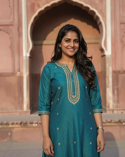Ananya, 27, Indian woman from Jaipur in a teal kurta near a pink sandstone palace archway